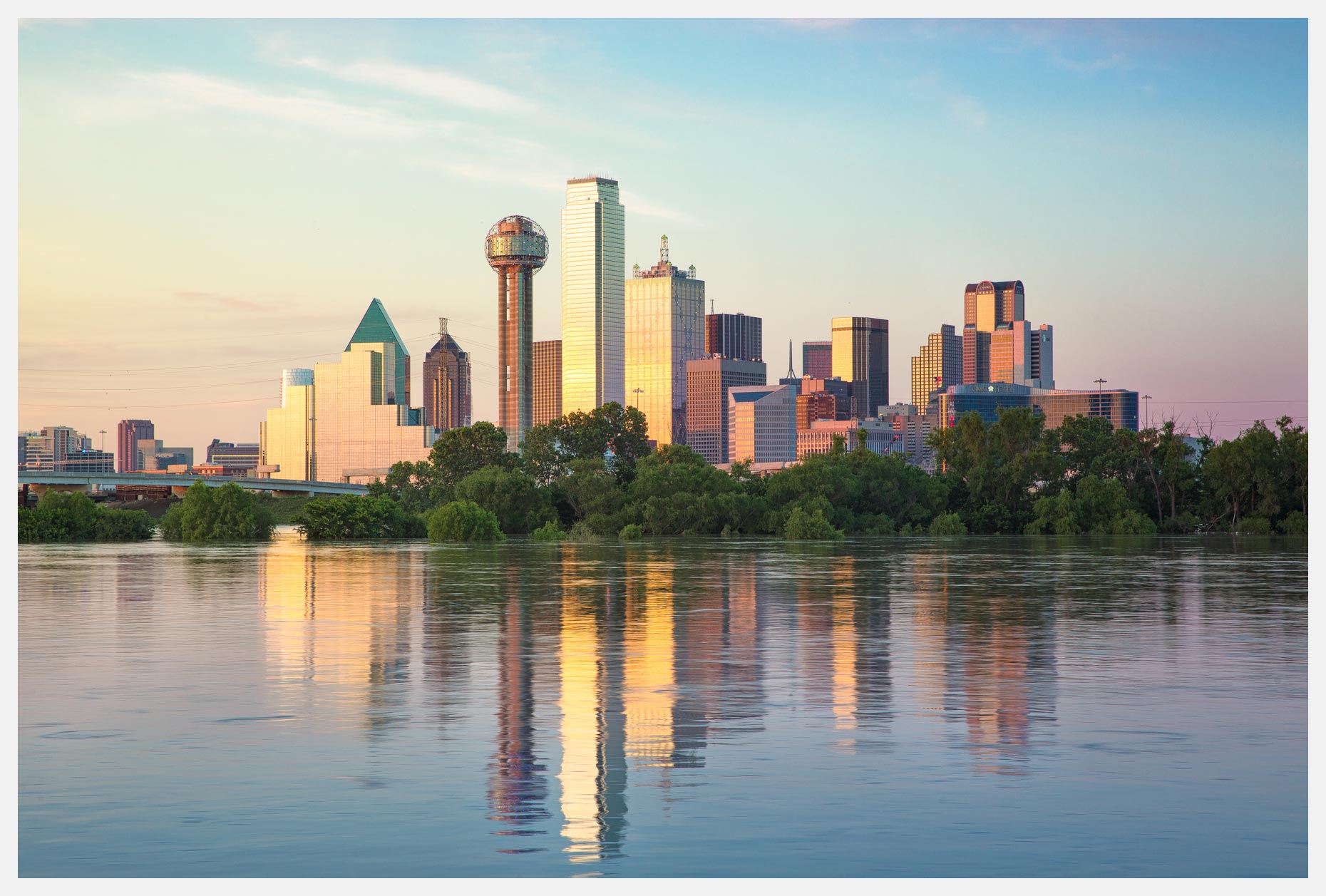 The Dallas Skyline at Sunset with reflections in water from the Trinity River